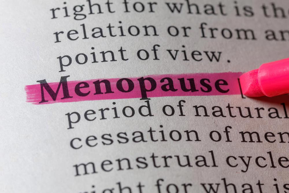 marker highlighting the word menopause in book